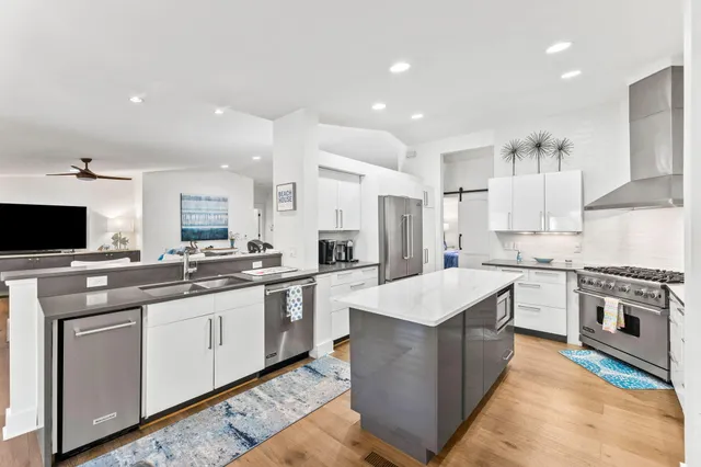 a kitchen with a sink stove and refrigerator