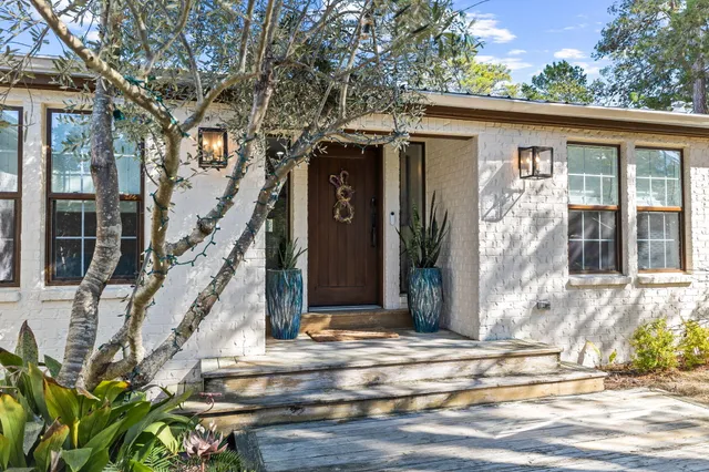 a view of a house with wooden floor and a tree
