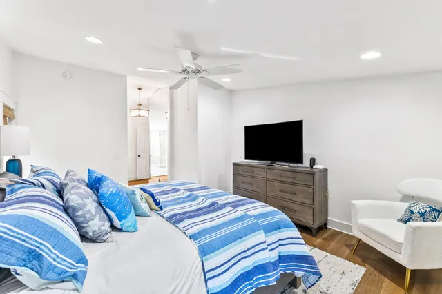 a bedroom with a bed and a flat screen tv