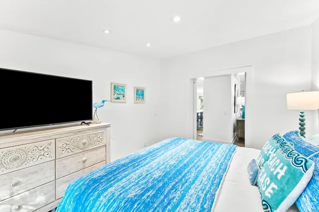 a bedroom with a bed and a flat screen tv