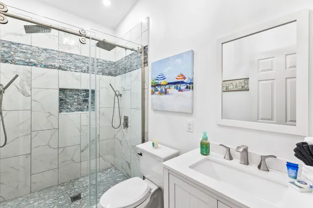 a bathroom with a sink toilet and shower