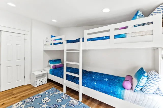 a bedroom with a bed a couch and a large window