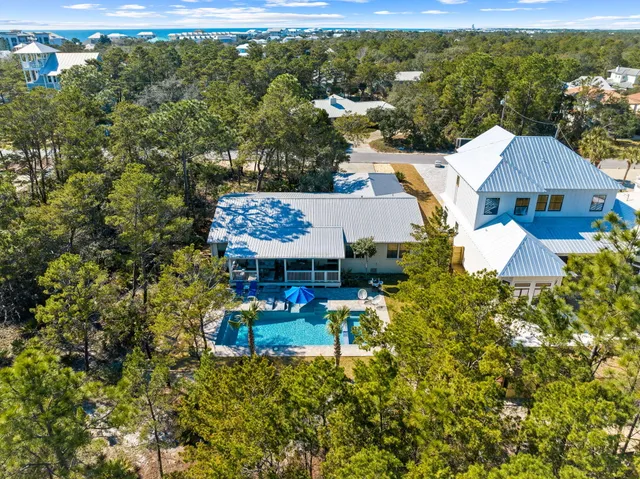 an aerial view of a house with a yard basket ball court and outdoor seating