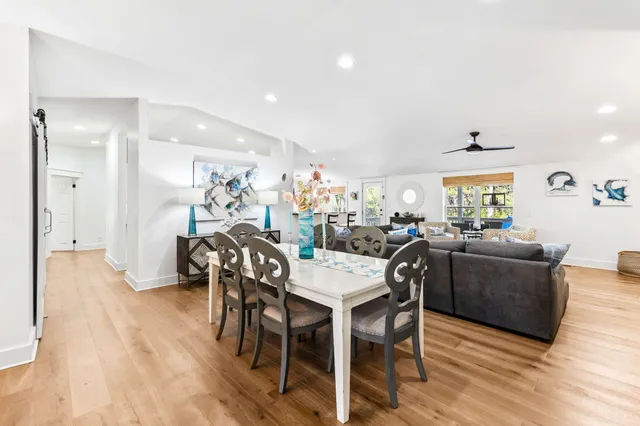 a dining room with furniture and wooden floor