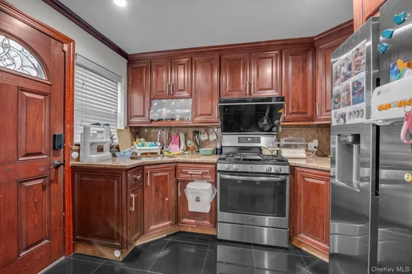 a kitchen with stainless steel appliances wooden cabinets and a stove top oven