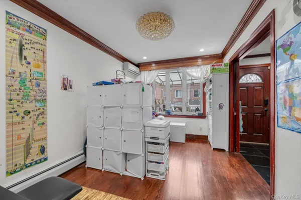 a view of a hallway with cabinet and wooden floor