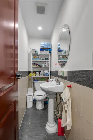 a bathroom with a sink toilet and a mirror
