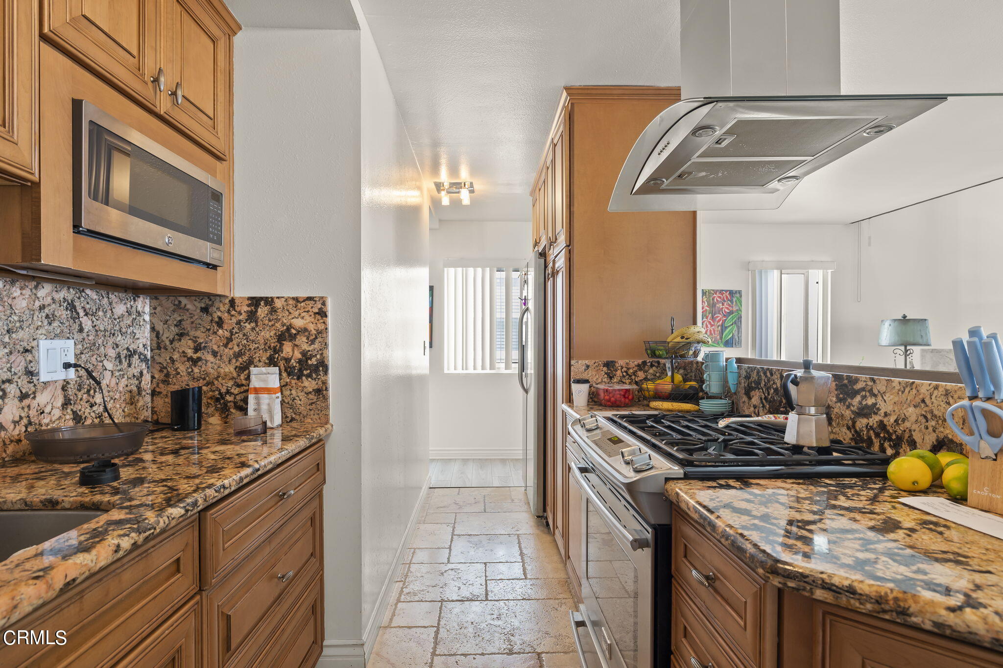 3551-3553 Sunset Lane Oxnard, CA 93035 - Photo 12 of 37 a kitchen with stainless steel appliances granite countertop a stove a sink and a refrigerator