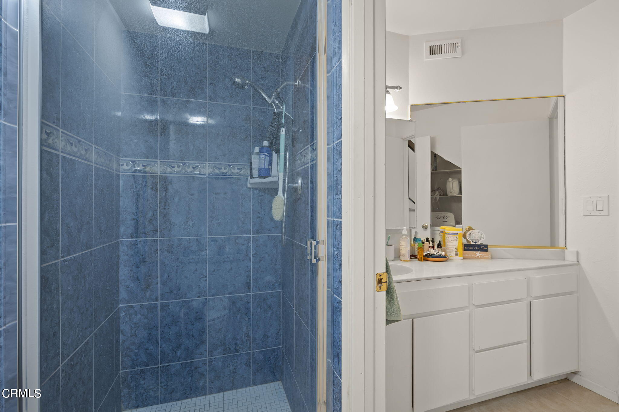 3551-3553 Sunset Lane Oxnard, CA 93035 - Photo 16 of 37 a bathroom with a sink mirror and shower