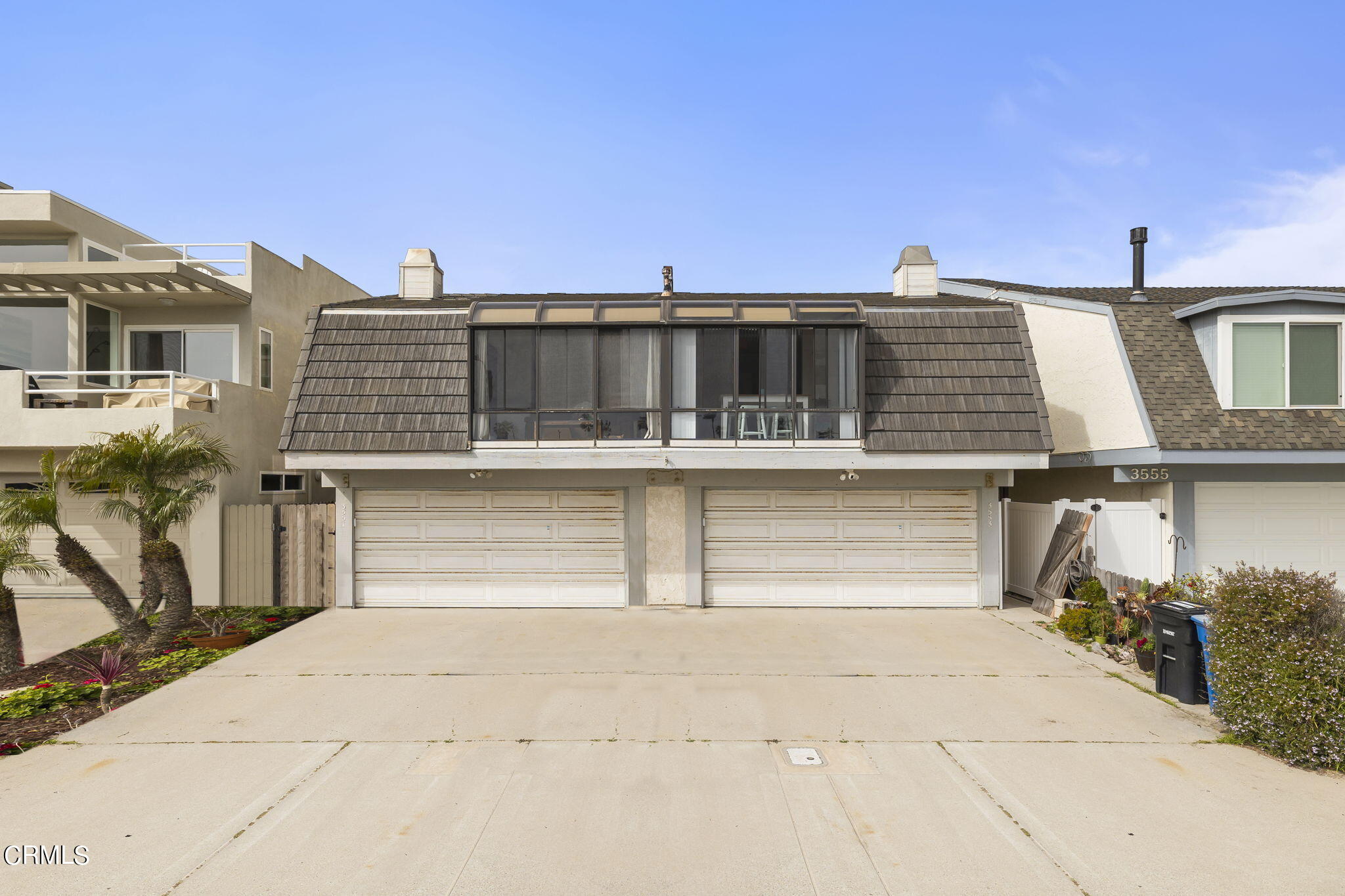 3551-3553 Sunset Lane Oxnard, CA 93035 - Photo 2 of 37 a front view of a house with a garage
