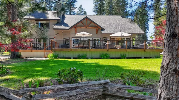 a front view of house with yard and outdoor seating