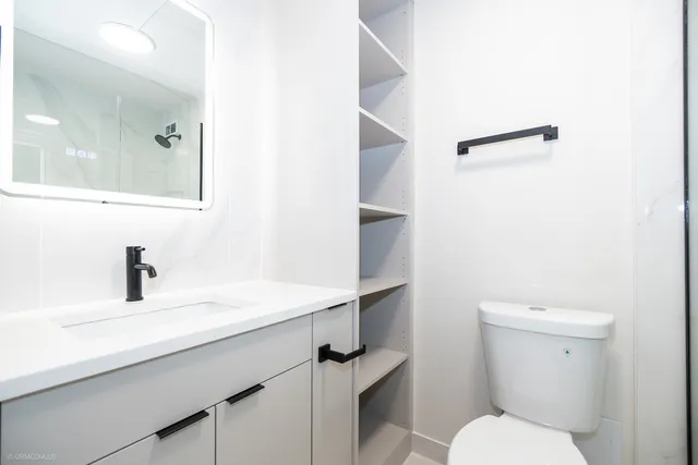 a bathroom with a toilet and a shower