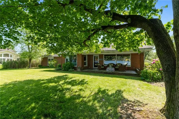 a view of a house with backyard and a swimming pool