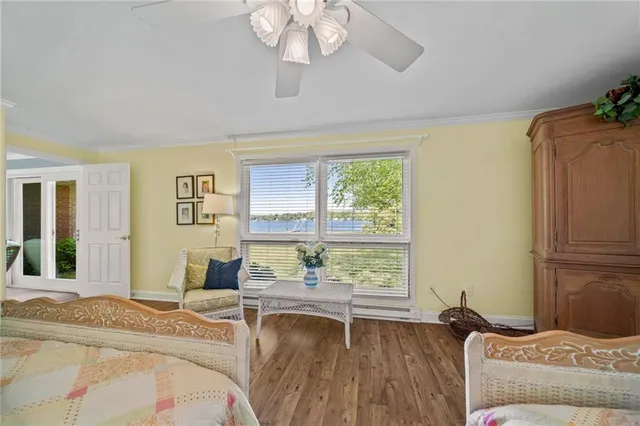 a living room with a bed furniture and a large window