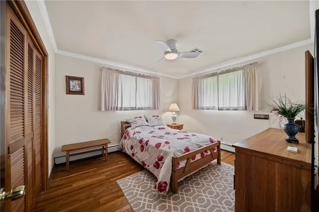 a bedroom with a bed and a potted plant