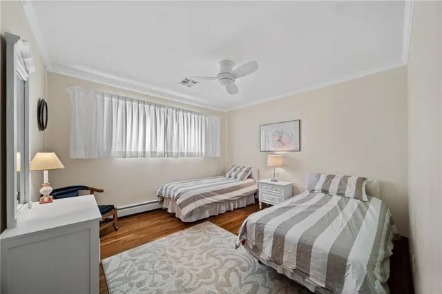 a bedroom with two beds and a lamp