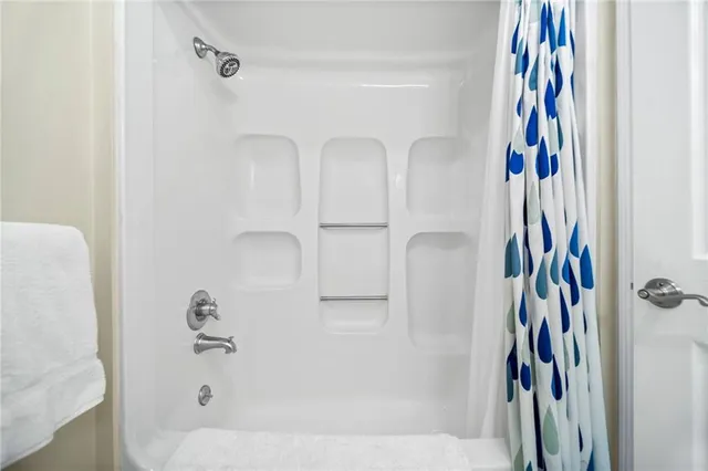 a bathroom with a bathtub and a shower