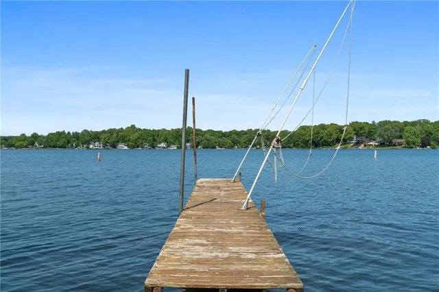 a view of a wooden deck with a lake