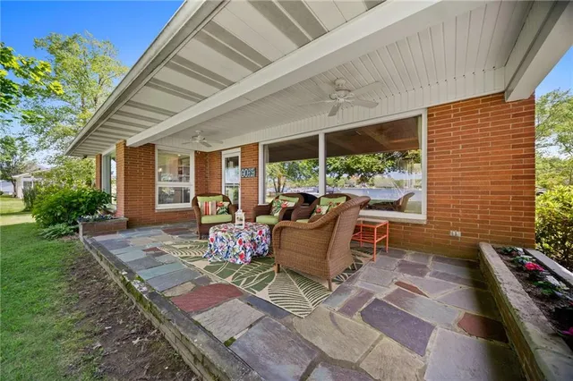 a patio with patio couch and a garden