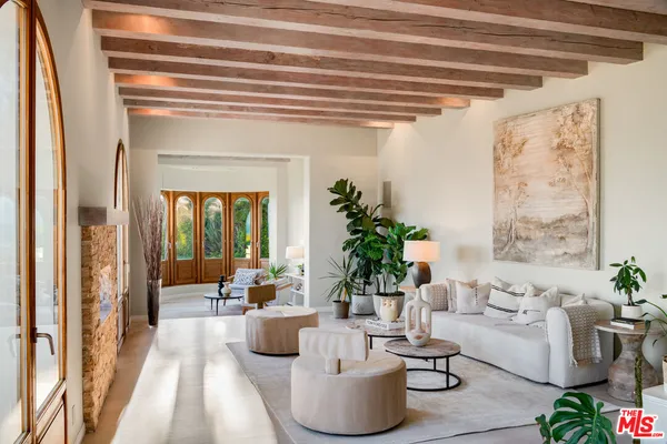a living room with furniture and a floor to ceiling window