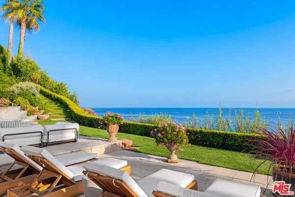 a view of an chairs and table on the patio