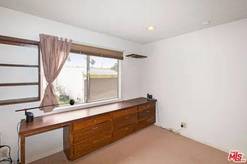 a view of room with window and cabinet