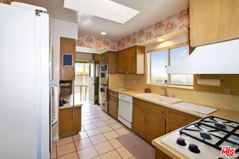 a kitchen with a sink appliances and cabinets
