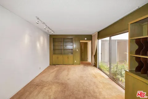 a view of empty room with a fireplace