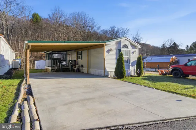 a view of a car park in front of a house