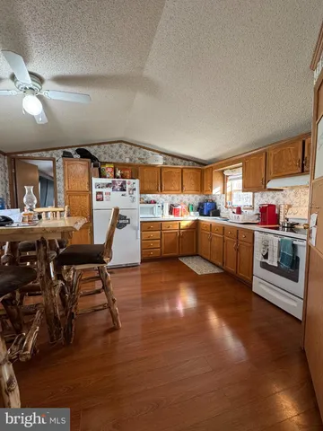 a living room with lots of furniture and kitchen view