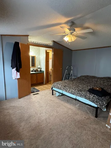 a bedroom with furniture and chandelier