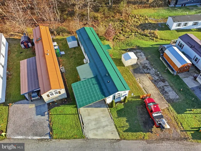 an aerial view of a pool patio chairs and fire pit