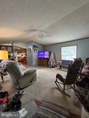 a living room with furniture a air conditioner vent and a window
