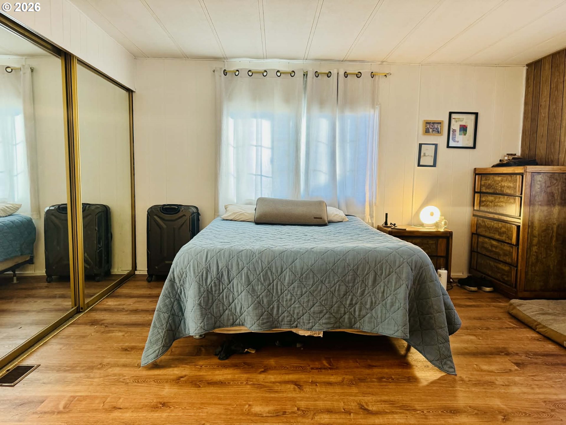 1020 South 2nd Street Union, OR 97883 - Photo 18 of 37 a bedroom with a bed a dresser and a walk in closet