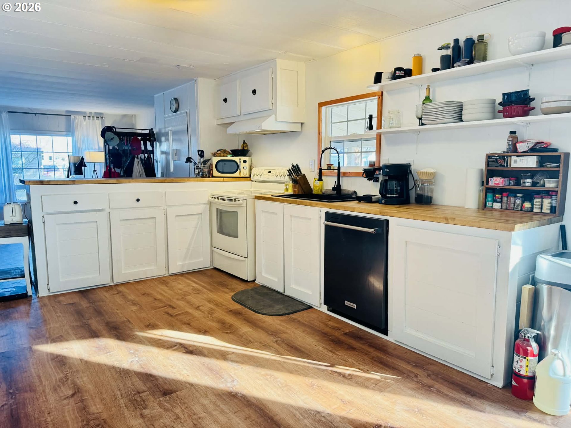 1020 South 2nd Street Union, OR 97883 - Photo 8 of 37 a kitchen with cabinets stainless steel appliances and wooden floor