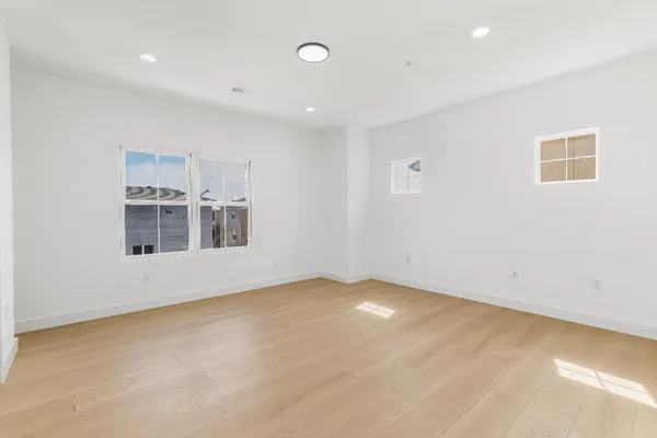 a view of a room with wooden floor and window