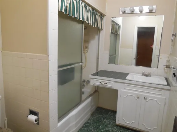 a utility room with cabinets washer and dryer