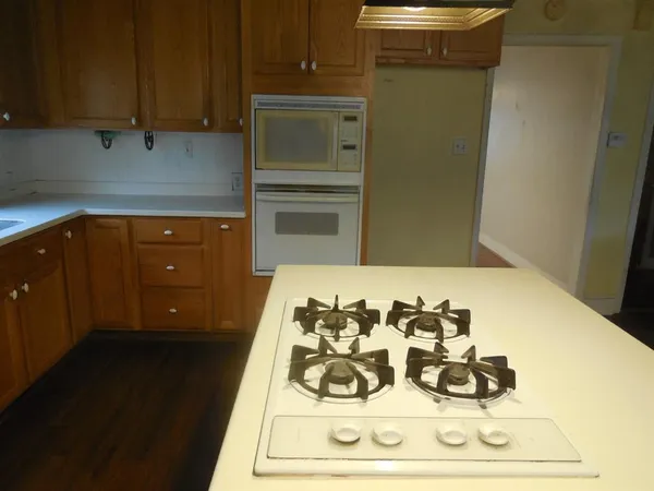 a kitchen with a refrigerator and cabinets