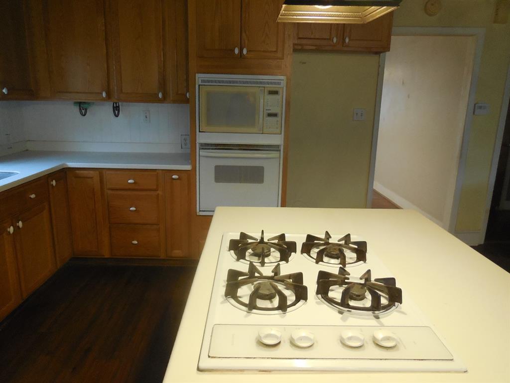 609 West Main Street Ranger, TX 76470 - Photo 15 of 29 a kitchen with a refrigerator and cabinets