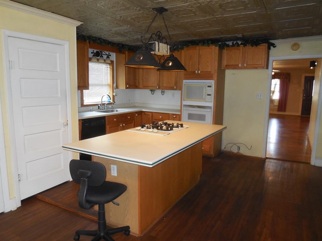 609 West Main Street Ranger, TX 76470 - Photo 16 of 29 a kitchen that has a sink a stove and wooden floor