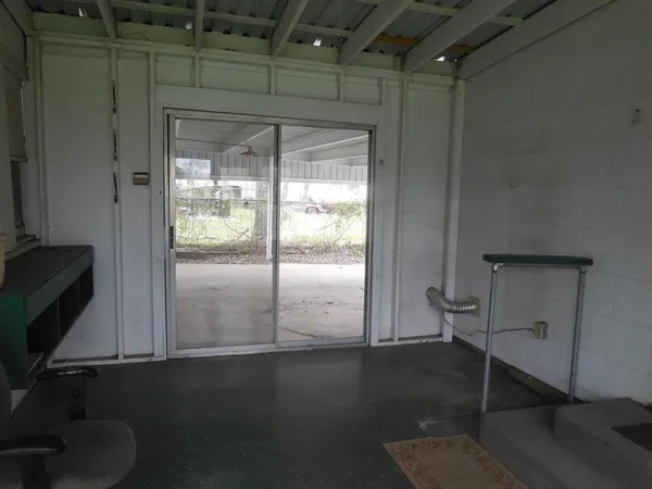 a room with wooden floor and windows