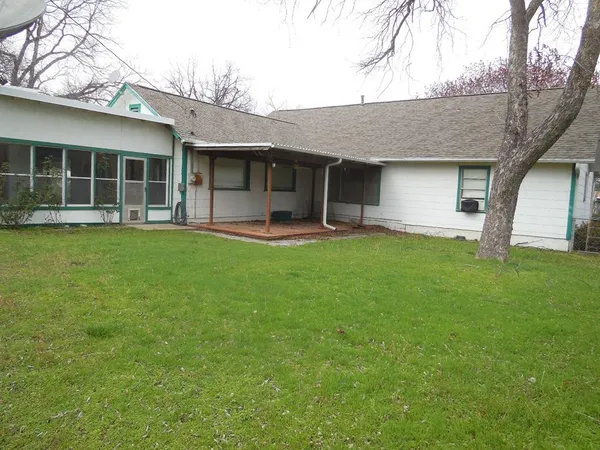 a front view of a house with a garden and yard