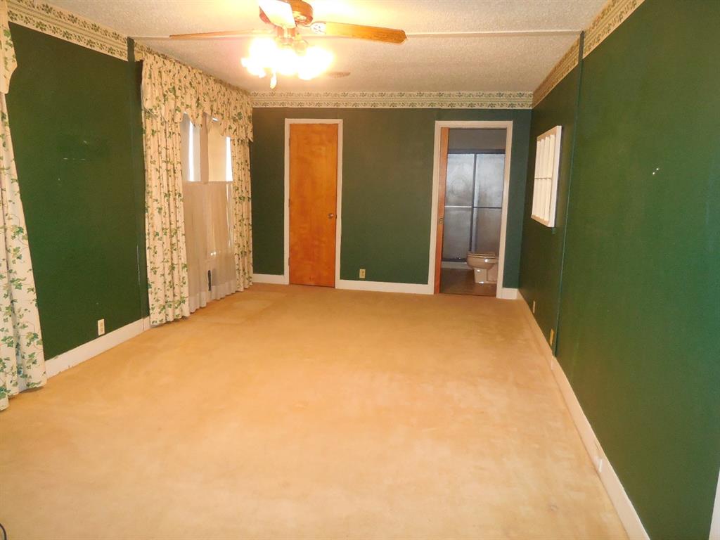 609 West Main Street Ranger, TX 76470 - Photo 4 of 29 a view of a big room with windows and chandelier