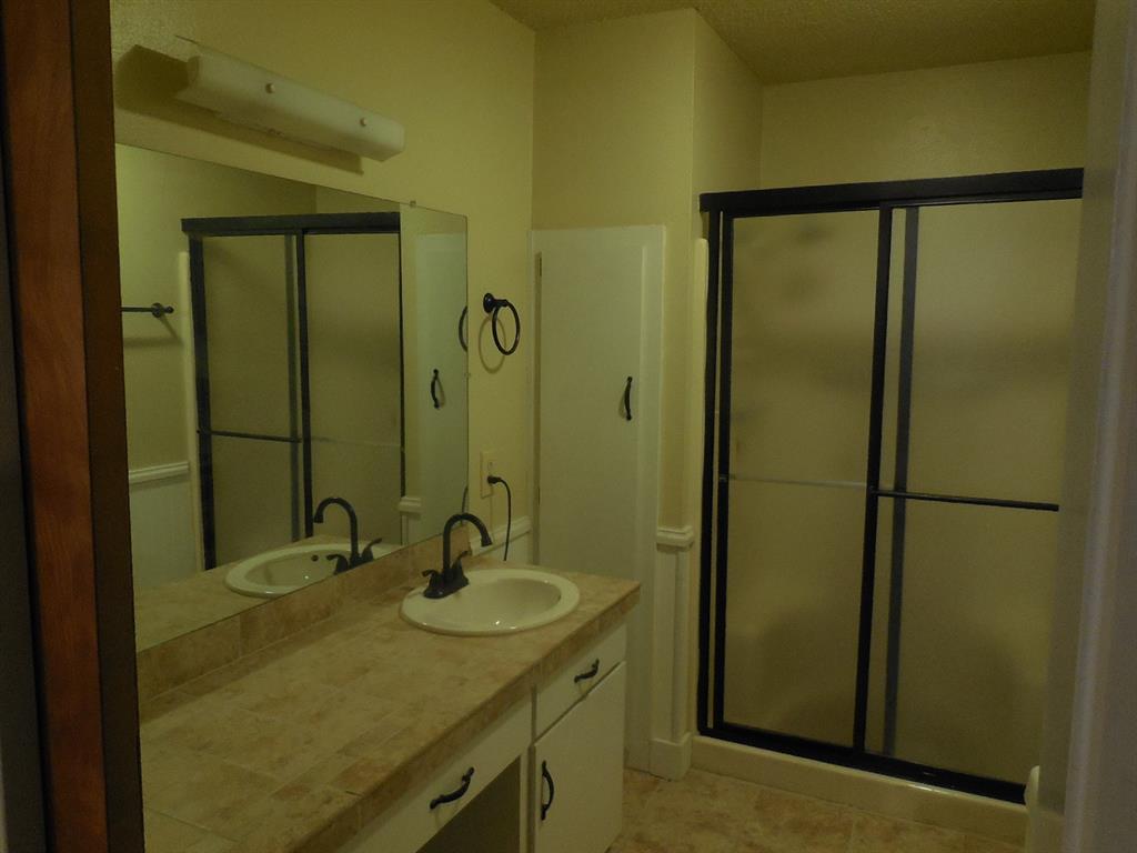 609 West Main Street Ranger, TX 76470 - Photo 5 of 29 a bathroom with a sink and a mirror