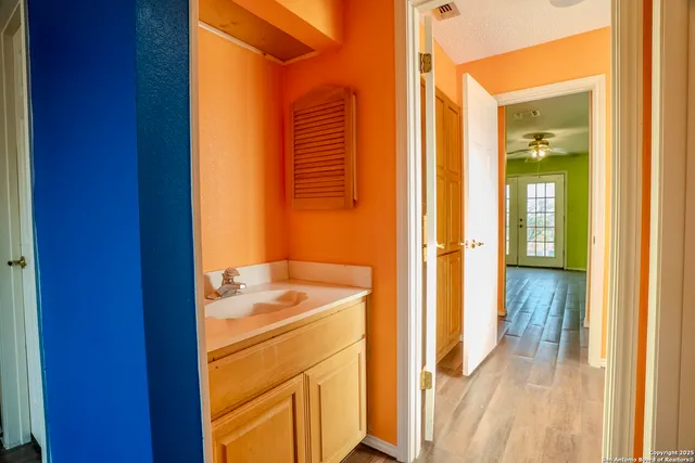 a view of a bathroom that has a sink and a mirror