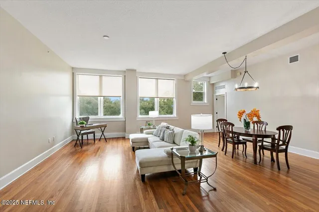 a living room with furniture and a wooden floor