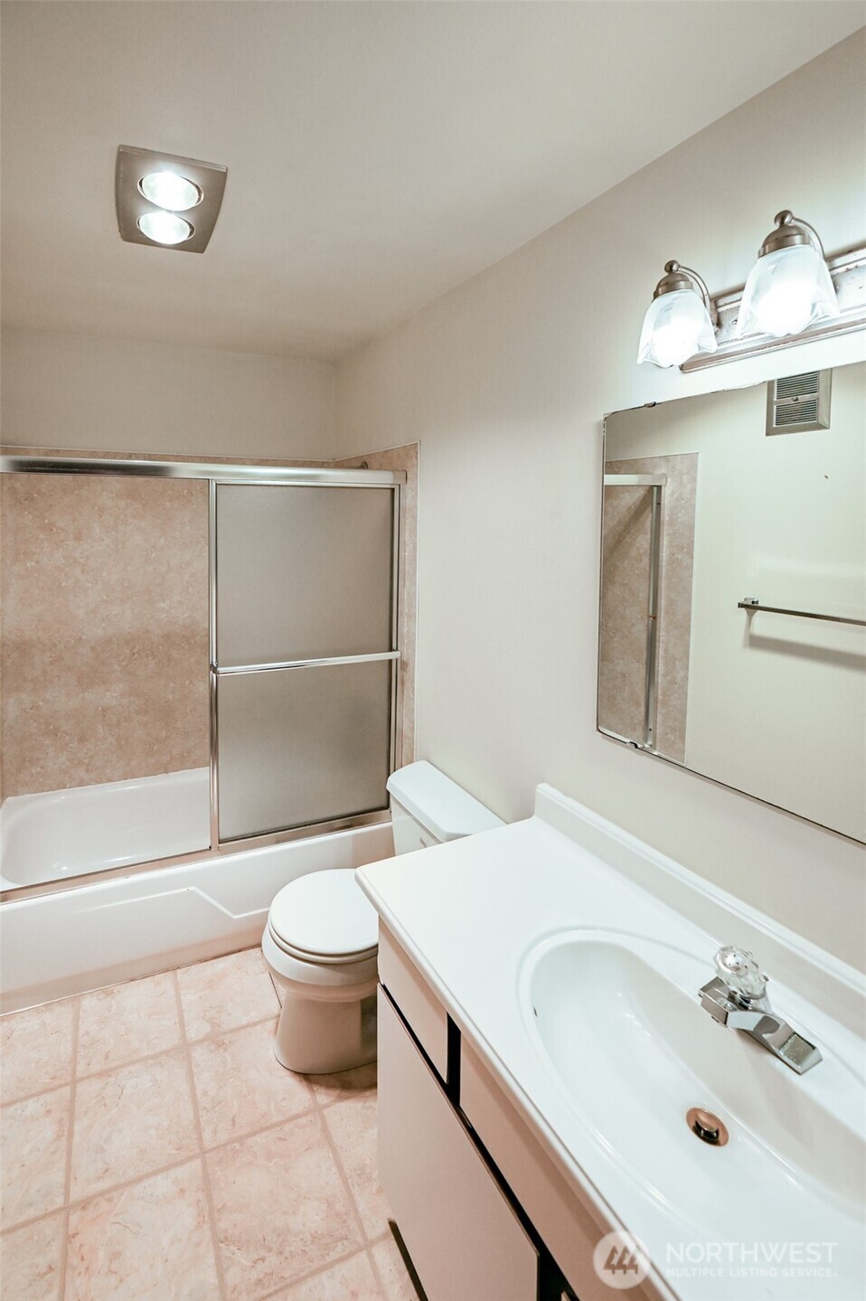 719 North 85th Street Seattle, WA 98103 - Photo 11 of 15 a bathroom with a sink toilet and a mirror