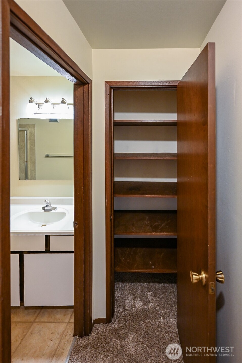 719 North 85th Street Seattle, WA 98103 - Photo 12 of 15 a bathroom with a sink and a mirror