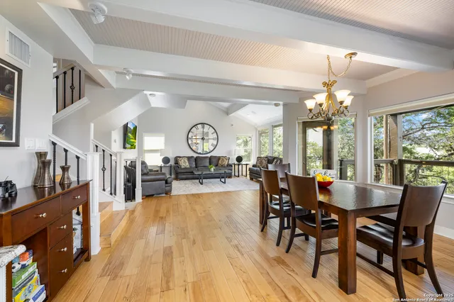 a living room with fireplace furniture and a large window