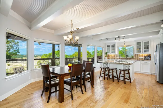a large kitchen with granite countertop a large window and a sink